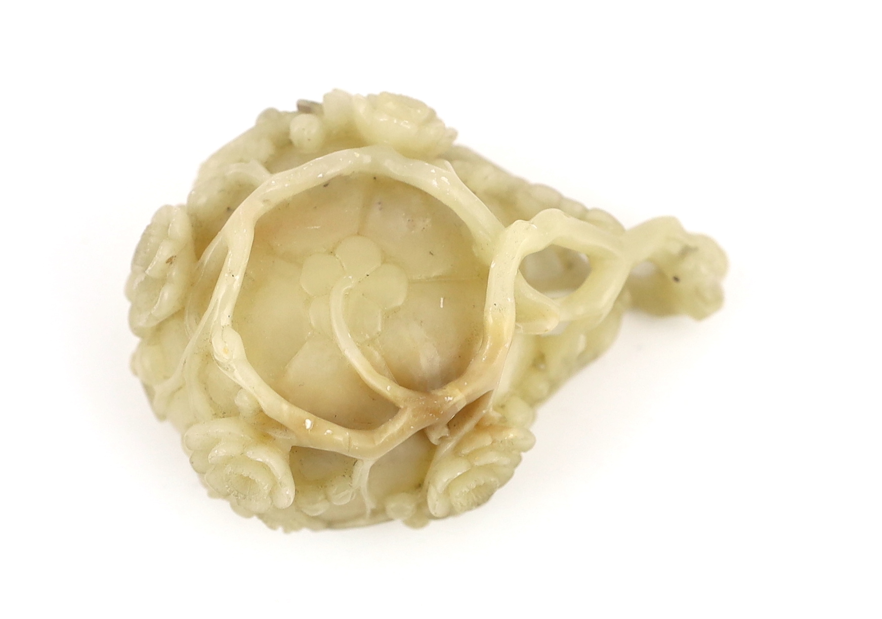 A Chinese creamy white soapstone ‘plum blossom’ cup, 18th/19th century, carved in high relief and open work with prunus branches and blossom, the stone of creamy white tone with some pale russet inclusions, 7.4cm across